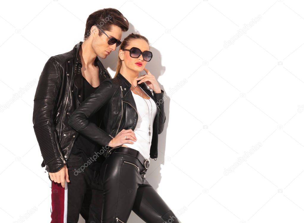 sexy woman in leather clothes standing near boyfriend