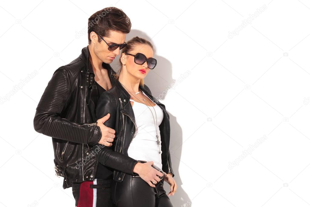 side view of a young couple in leather jackets 