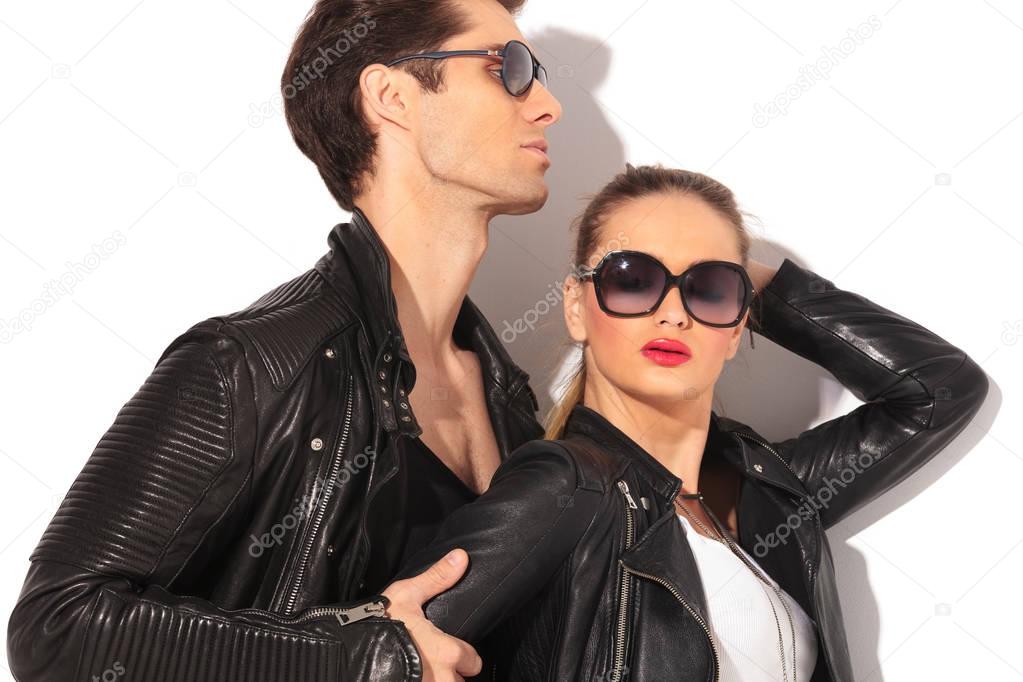 closeup of a young hot couple in leather jackets 