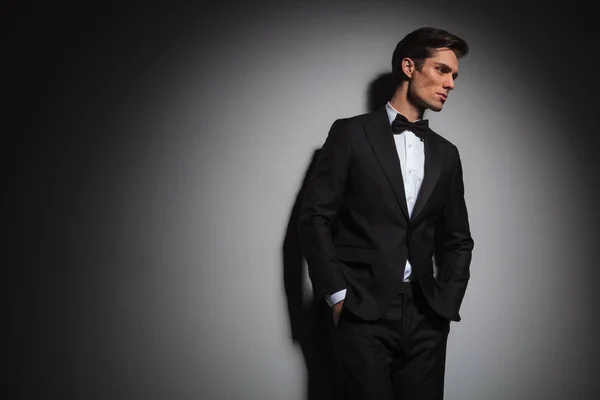 Pensive elegant man wearing tuxedo looks away to side — Stock Photo, Image