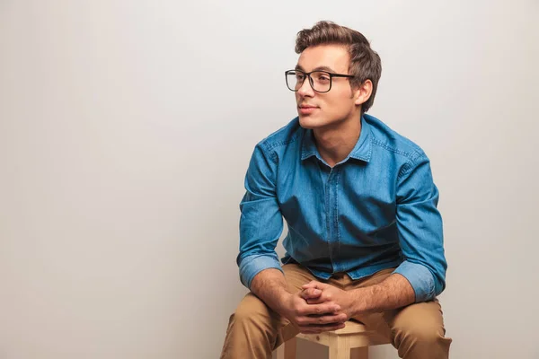 Seated young student is thinking — Stock Photo, Image