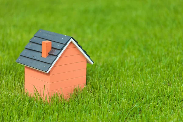 Little toy house in the grass — Stock Photo, Image