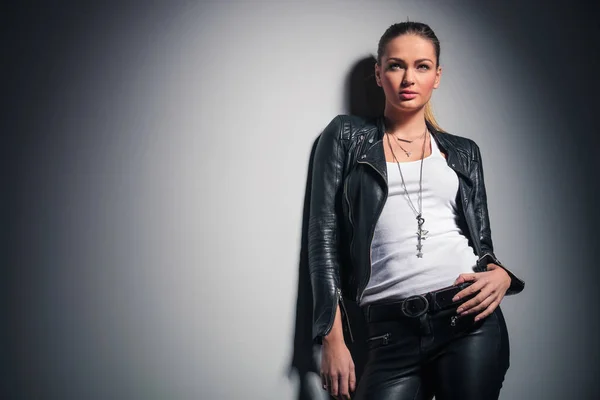 Young woman in leather clothes looks up — Stock Photo, Image