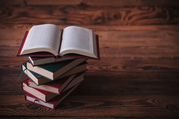 Open book on top of pile of books — Stock Photo, Image