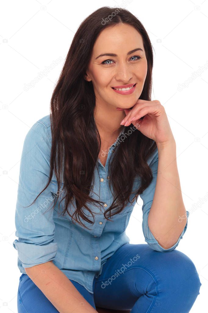 smiling casual woman sitting and thinking