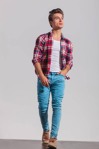walking young casual man looking up to side