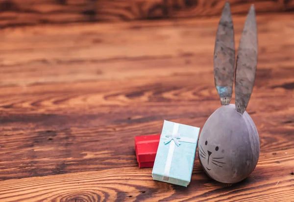 easter gifts and a cute grey egg with bunny ears