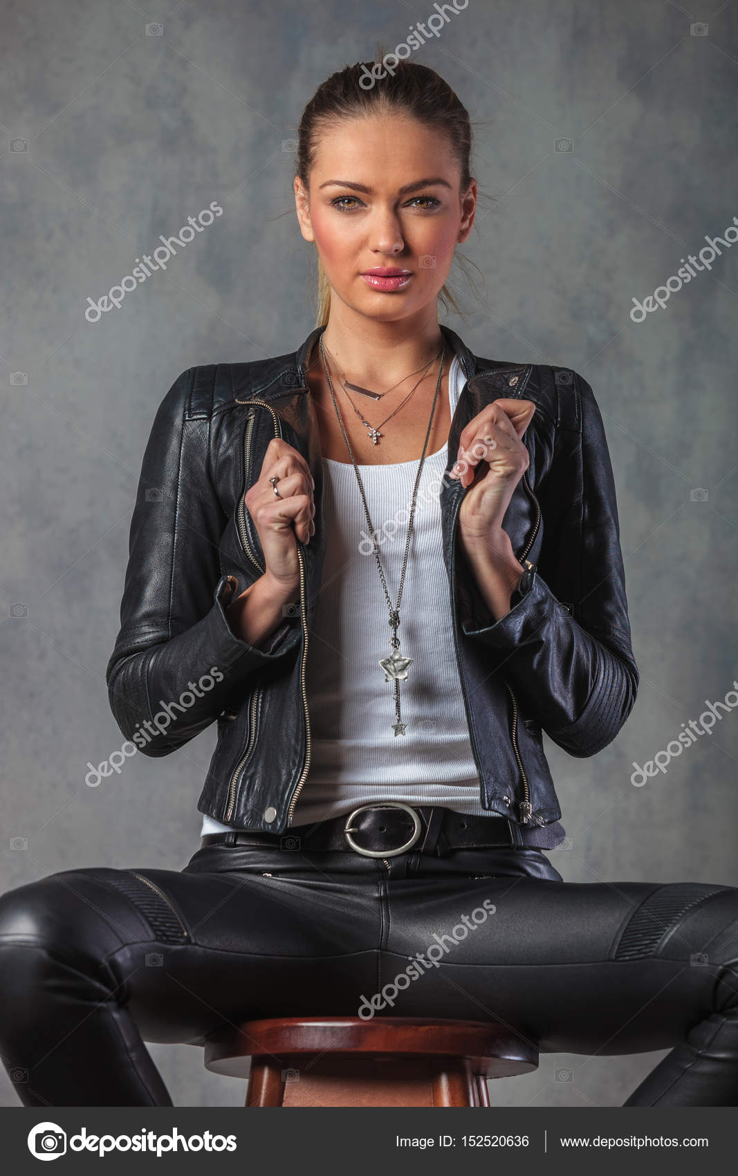 Sexy young blond woman in leather jacket pulling collar Stock Photo by ...