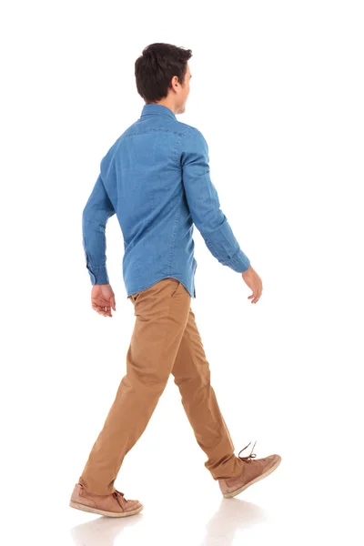 Atrás vista lateral de un joven caminante hombre casual — Foto de Stock