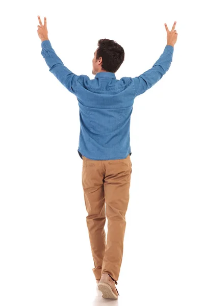 Back of a  man walking with hands up making victory — Stock Photo, Image