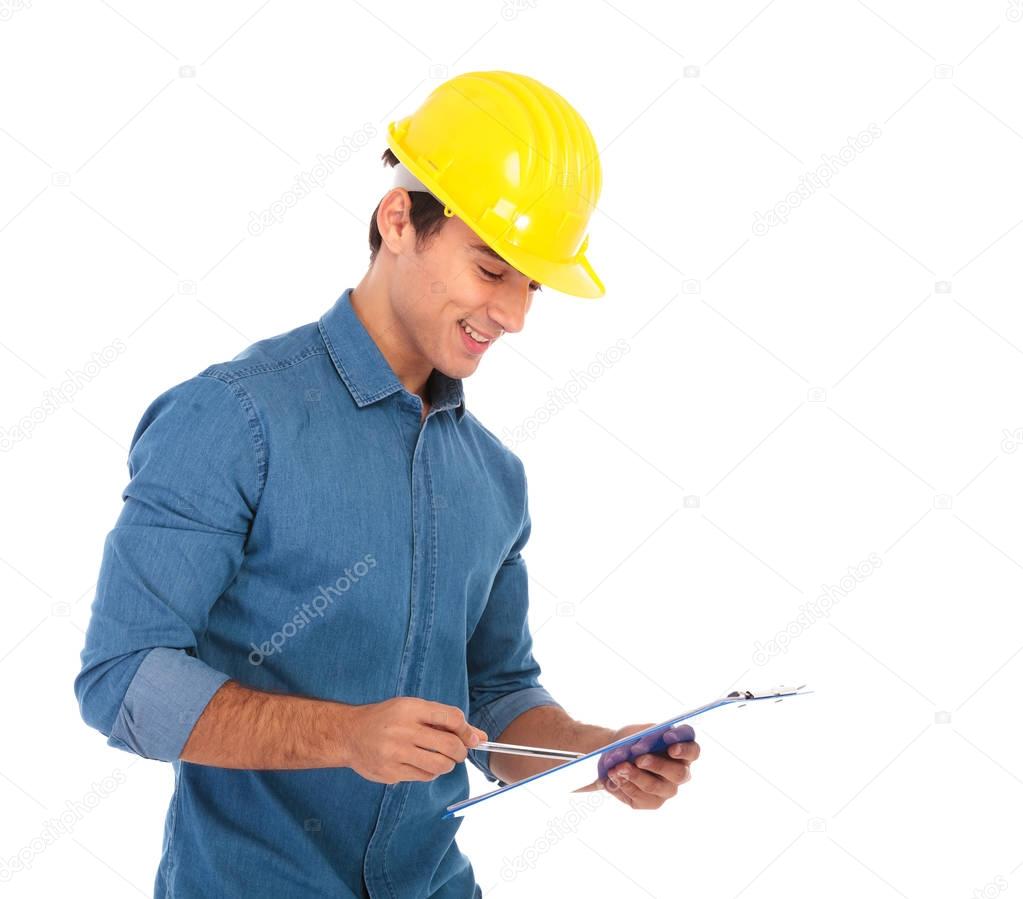 smiling construction engineering student reading his notes 