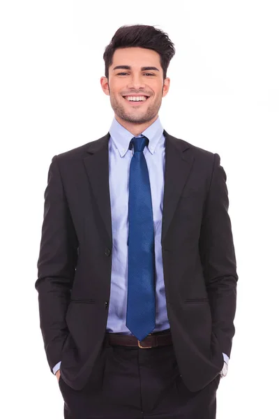Laughing young businessman standing with hands in pockets — Stock Photo, Image