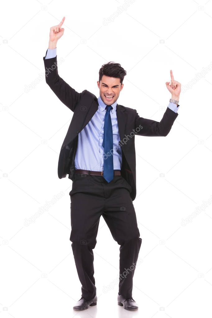 young businessman celebrating success with hands up