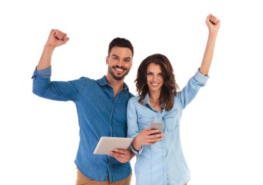 casual kaç Tablet ve telefon tutarak kutluyor gülümseyen