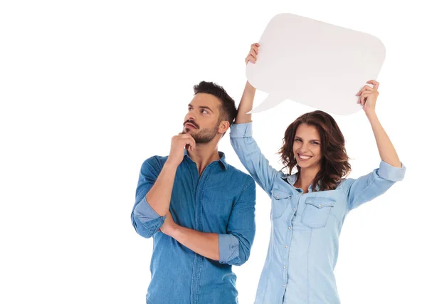 Woman holding speech bubble near man to show his thoughts — Stock Photo, Image