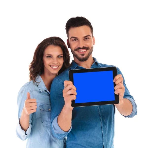 Woman shows  ok  behind man showing the  screen of tablet — Stock Photo, Image