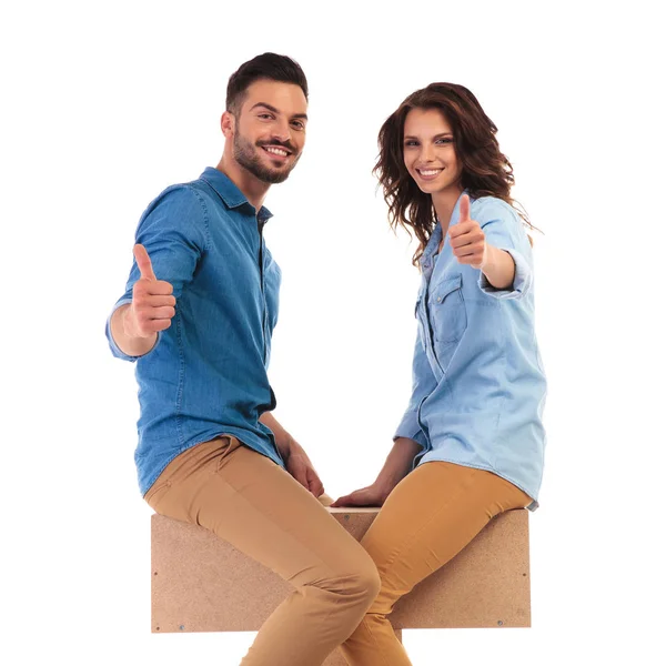 Seated  couple facing each other make the ok sign together — Stock Photo, Image