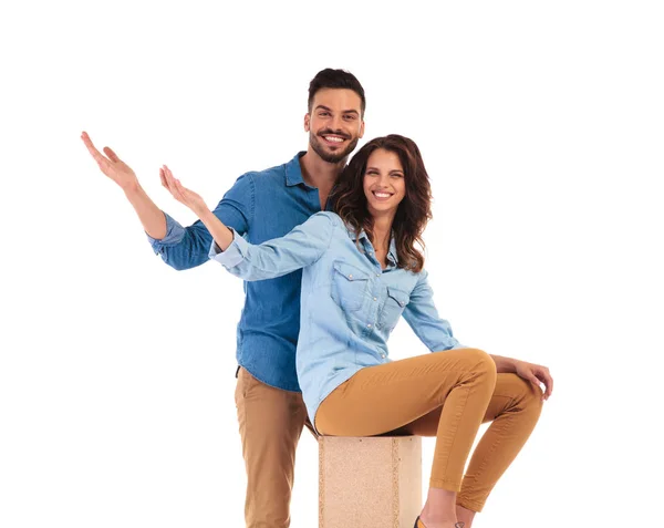 Happy young casual couple welcoming you — Stock Photo, Image