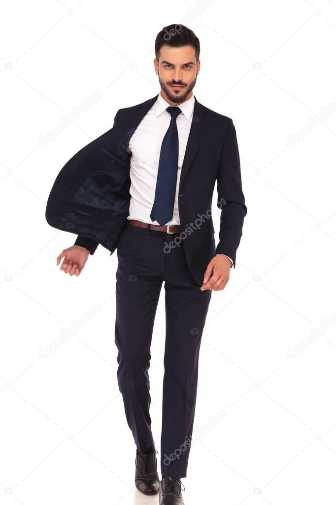happy confident business man walking with flying open jacket 