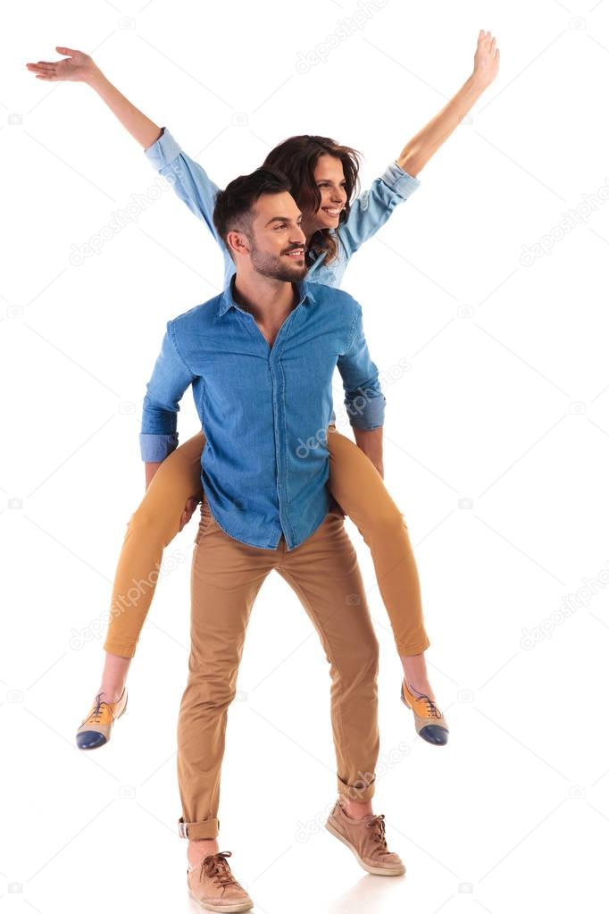side view of a young casual couple celebrating success 