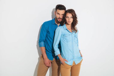 young casual couple posing for the camera  clipart
