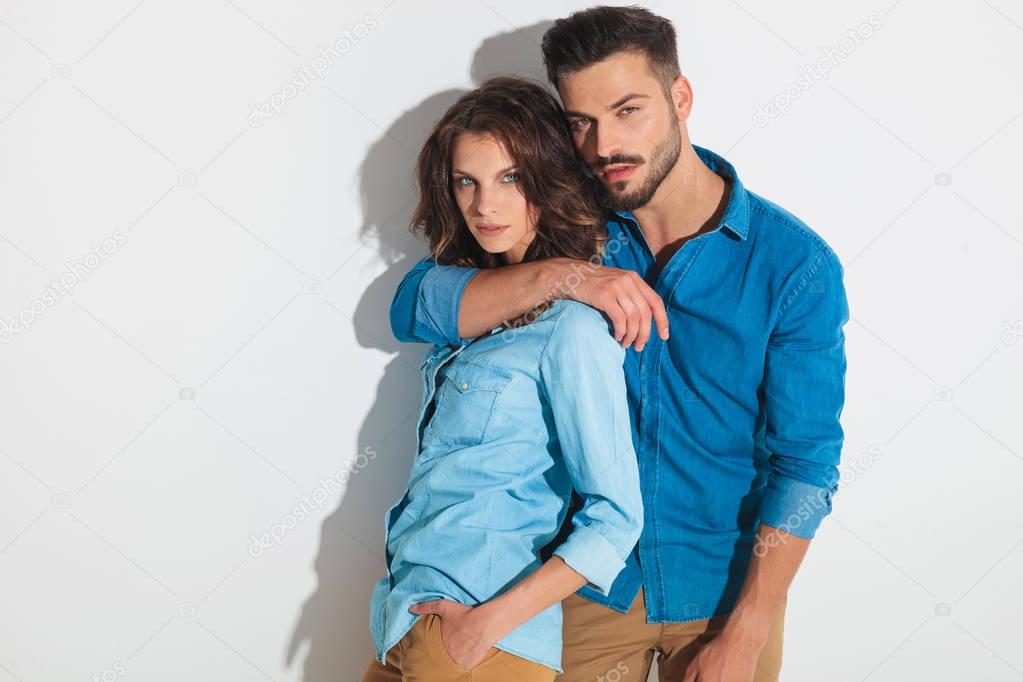 hot young casual couple standing embraced