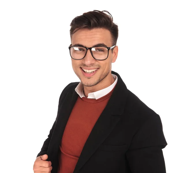 Young laughing man in glasses and long coat — Stock Photo, Image