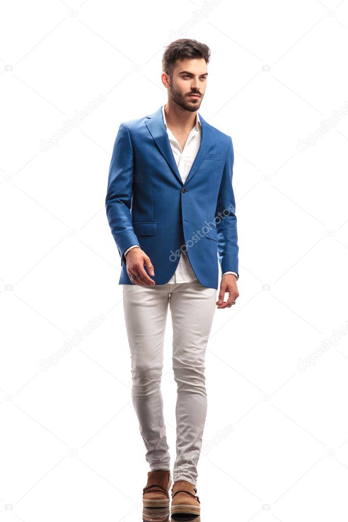 walking young modern man looks to side
