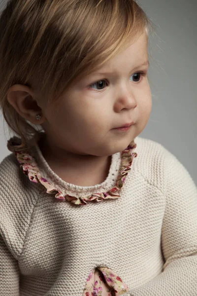 Πλευρά πορτρέτο του ένα χαριτωμένο κοριτσάκι που φοράει πλεκτό φόρεμα — Φωτογραφία Αρχείου