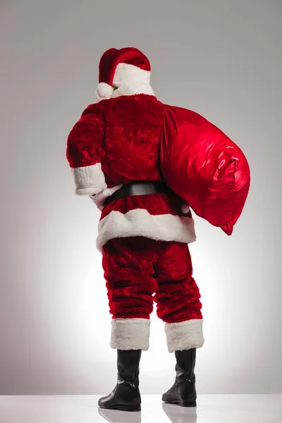 Back view of santa claus with bag on shoulder — Stock Photo, Image