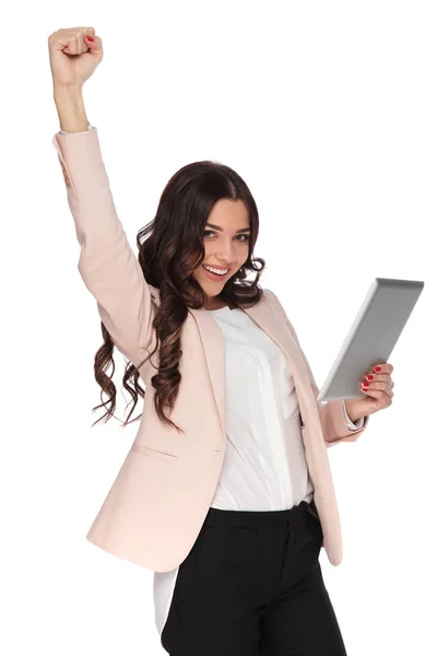 Excited young business woman celebrates success while holding ta — Stock Photo, Image