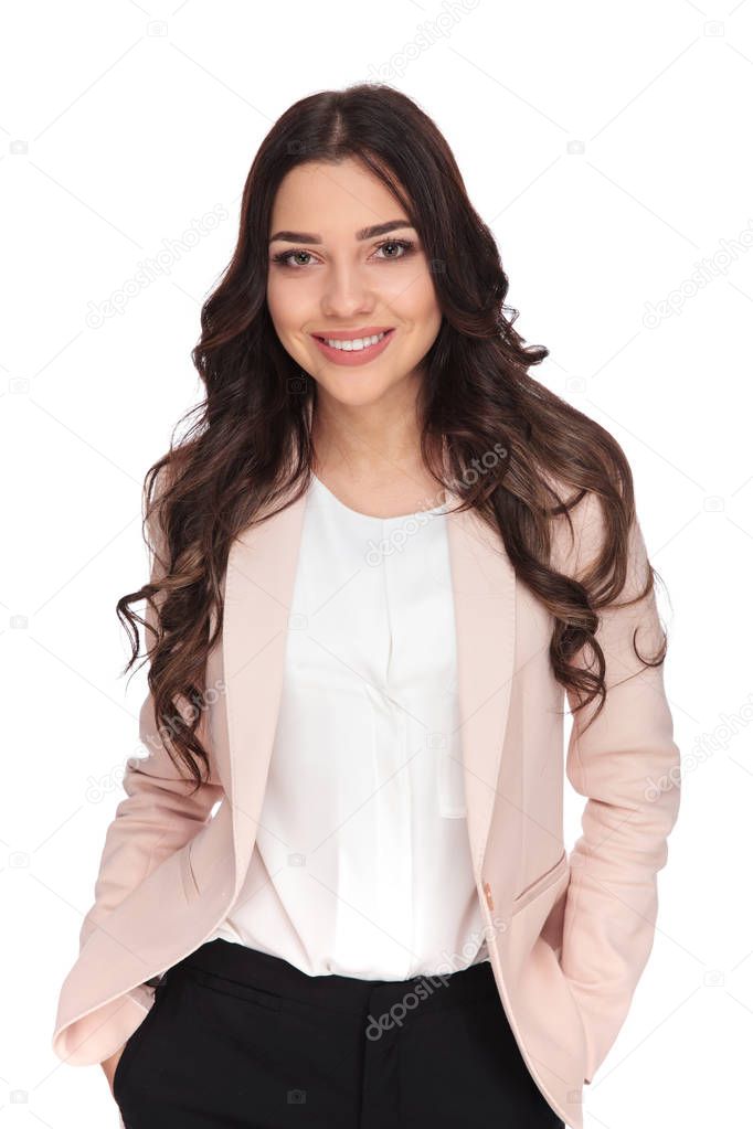 business woman standing with hands in pockets and smiles