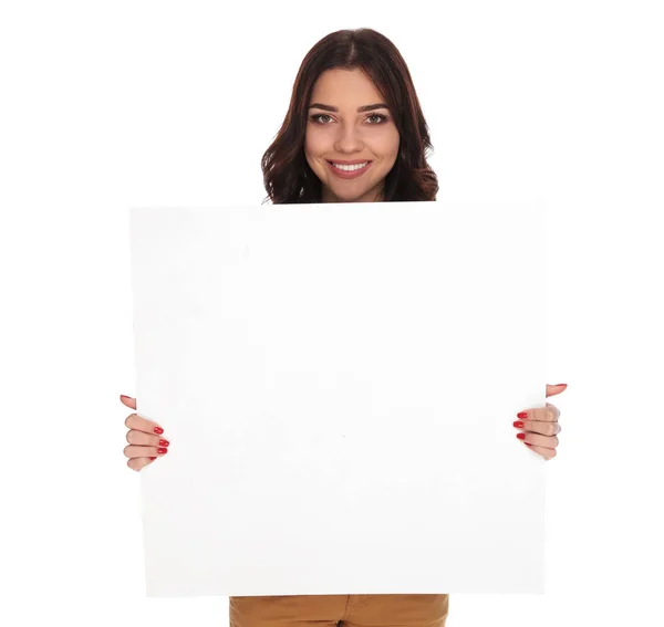 Sonriente mujer sosteniendo y mostrando un tablero en blanco —  Fotos de Stock