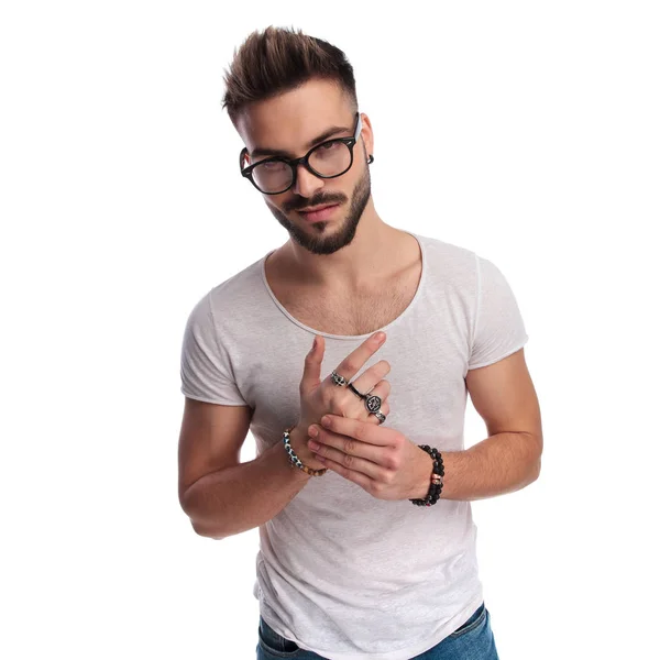 Smiling young casual man showing his rings — Stock Photo, Image