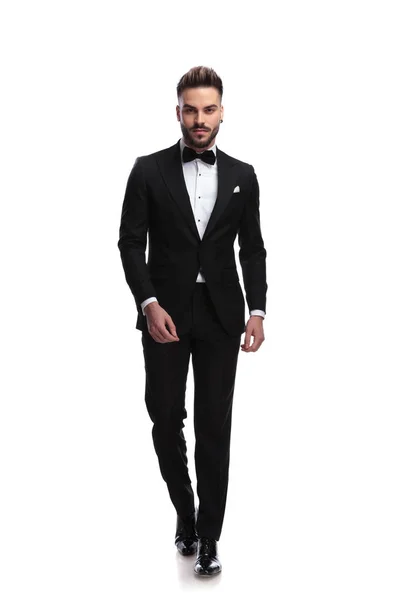 Happy young male fashion model in tuxedo is walking — Stock Photo, Image