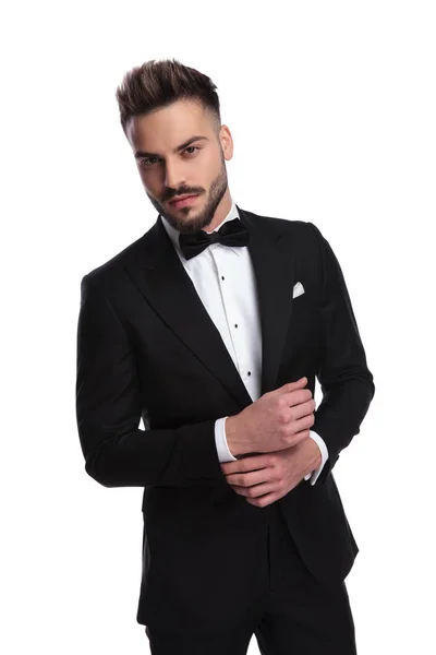 Elegant man in tuxedo fixing his sleeve — Stock Photo, Image