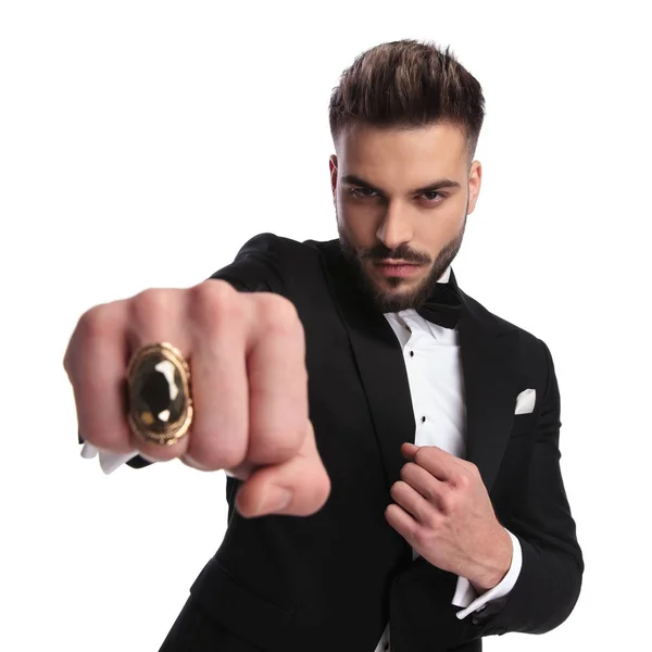 Macho elegant man in tuxedo showing his fist — Stock Photo, Image