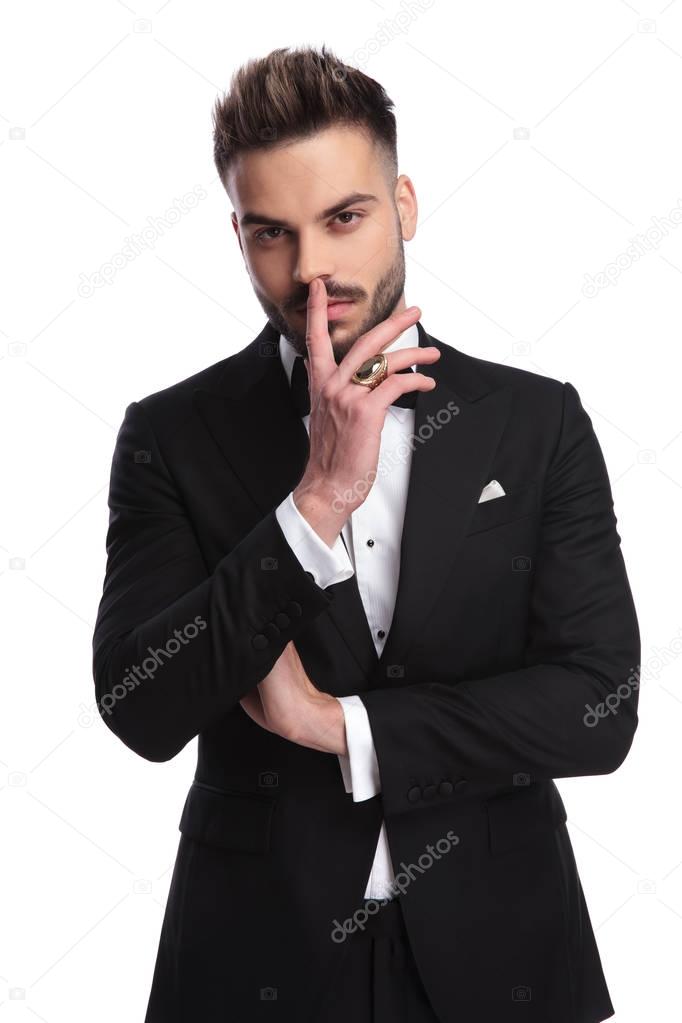 elegant man in tuxedo is thinking