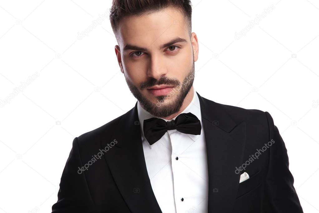 closeup portrait of a smiling young elegant man in tuxedo