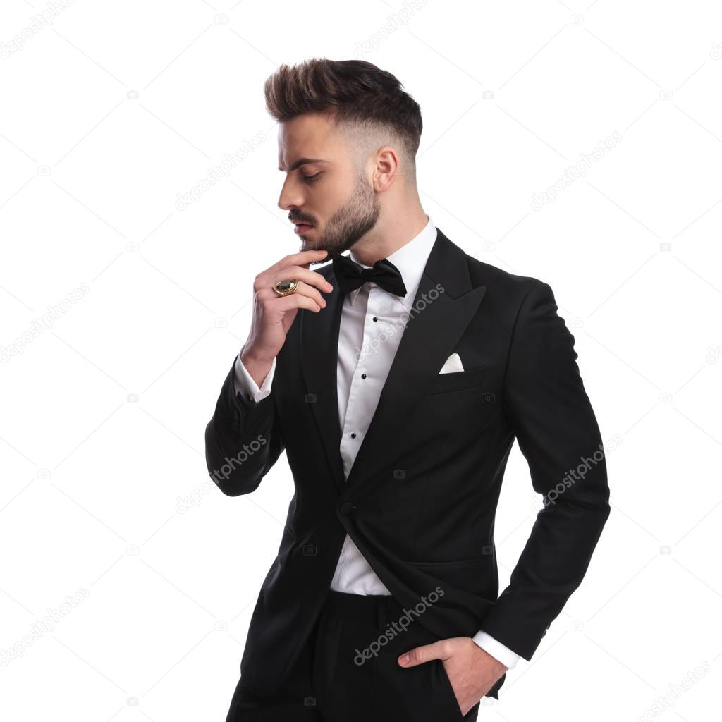profile portrait of a pensive elegant man in ceremony suit