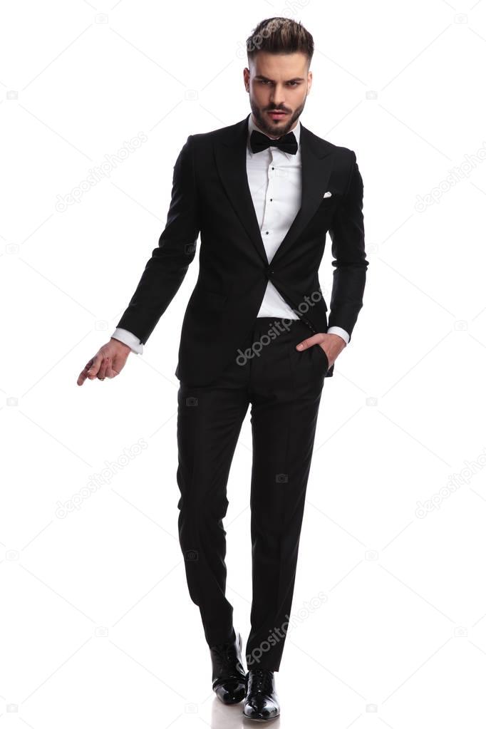cool dramatic man in tuxedo snapping fingers 