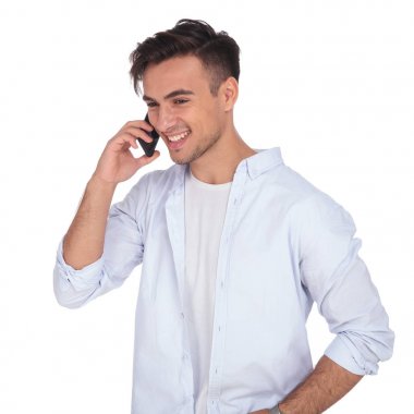 üstünde belgili tanımlık telefon ve gülüyor konuşurken rahat genç adam 