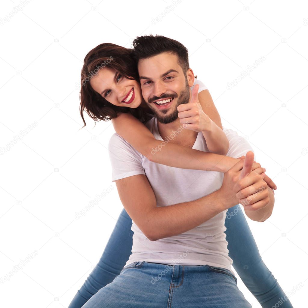 happy young couple making ok sign together 