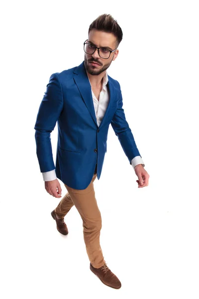 Sexy smart casual man walking looks to side — Stock Photo, Image