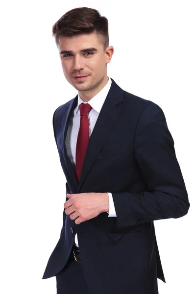 Handsome businessman smiling and buttoning his navy suit — Stock Photo, Image