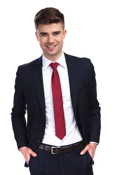 Relaxed businessman smiling with hands in pockets — Stock Photo, Image