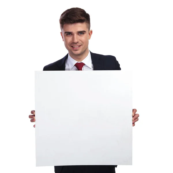 Portrait of businessman holding a white empty billboard — Stock Photo, Image