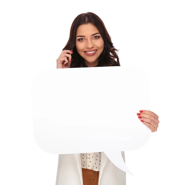 Smiling businesswoman holding empty board while talking on the p — Stock Photo, Image