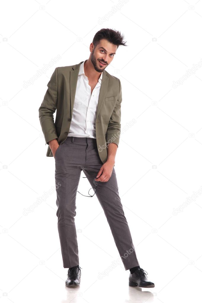 smiling stylish man looking relaxed while holding glasses
