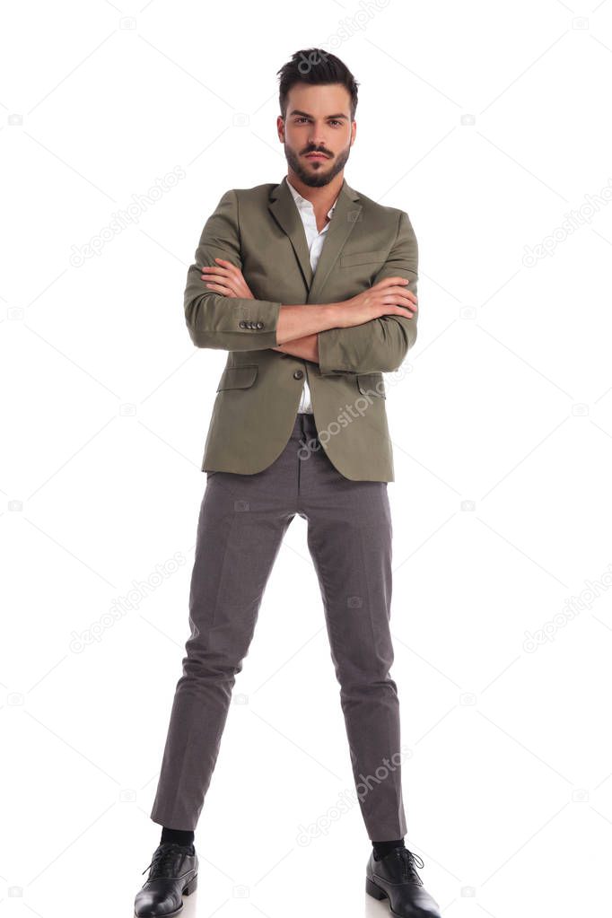 confident stylish man with green suit standing